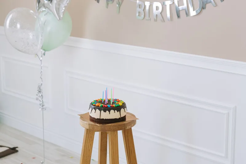Birthday cake displayed on a stool for a celebration