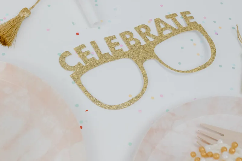 Party table set with colourful decorations and serving supplies